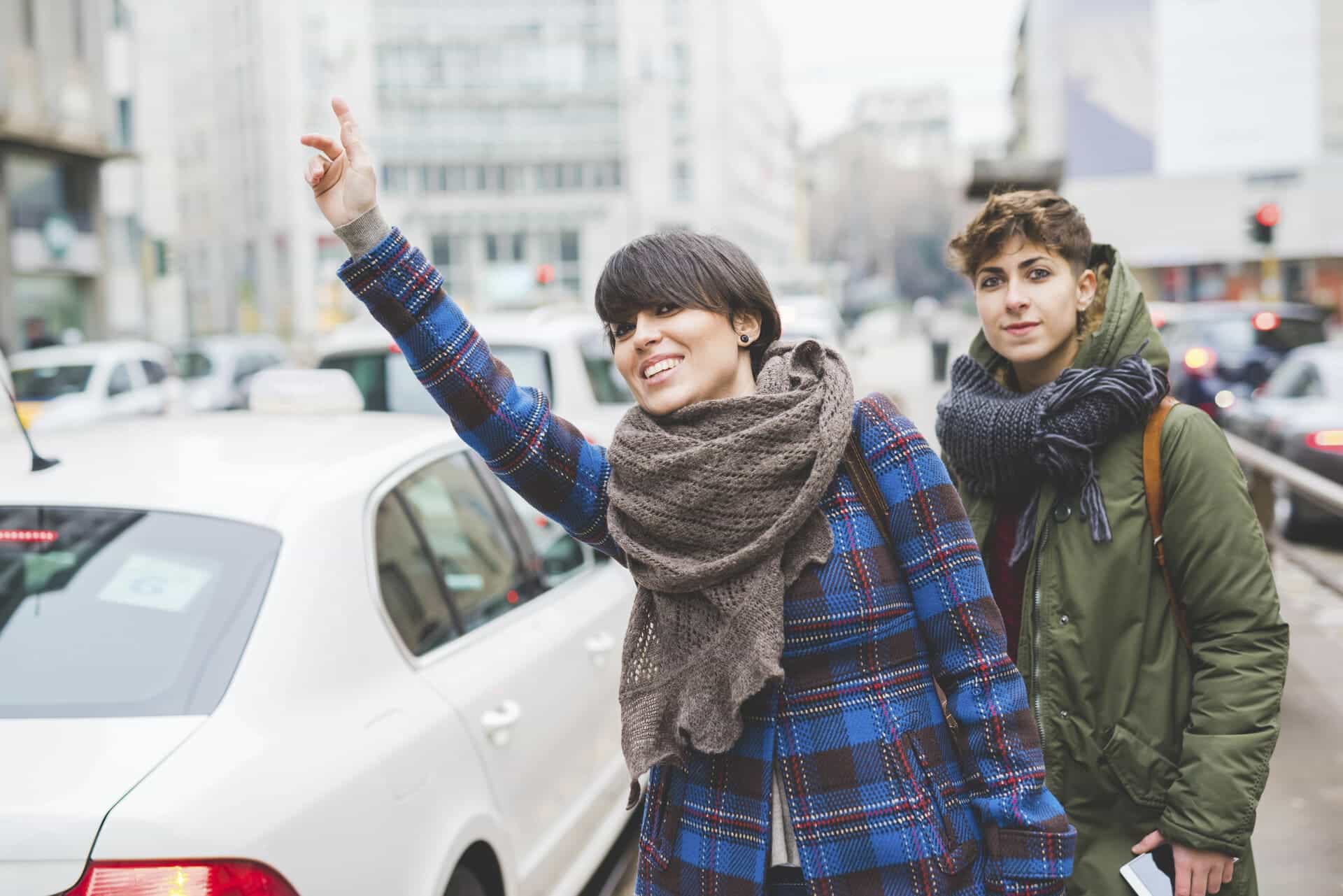 two sisters hailing taxi